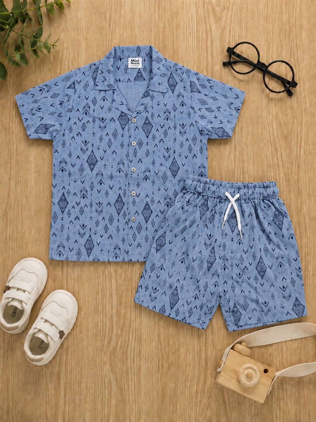 Boys light blue chambray short-sleeve button-down shirt and matching shorts set with navy tribal geometric print.