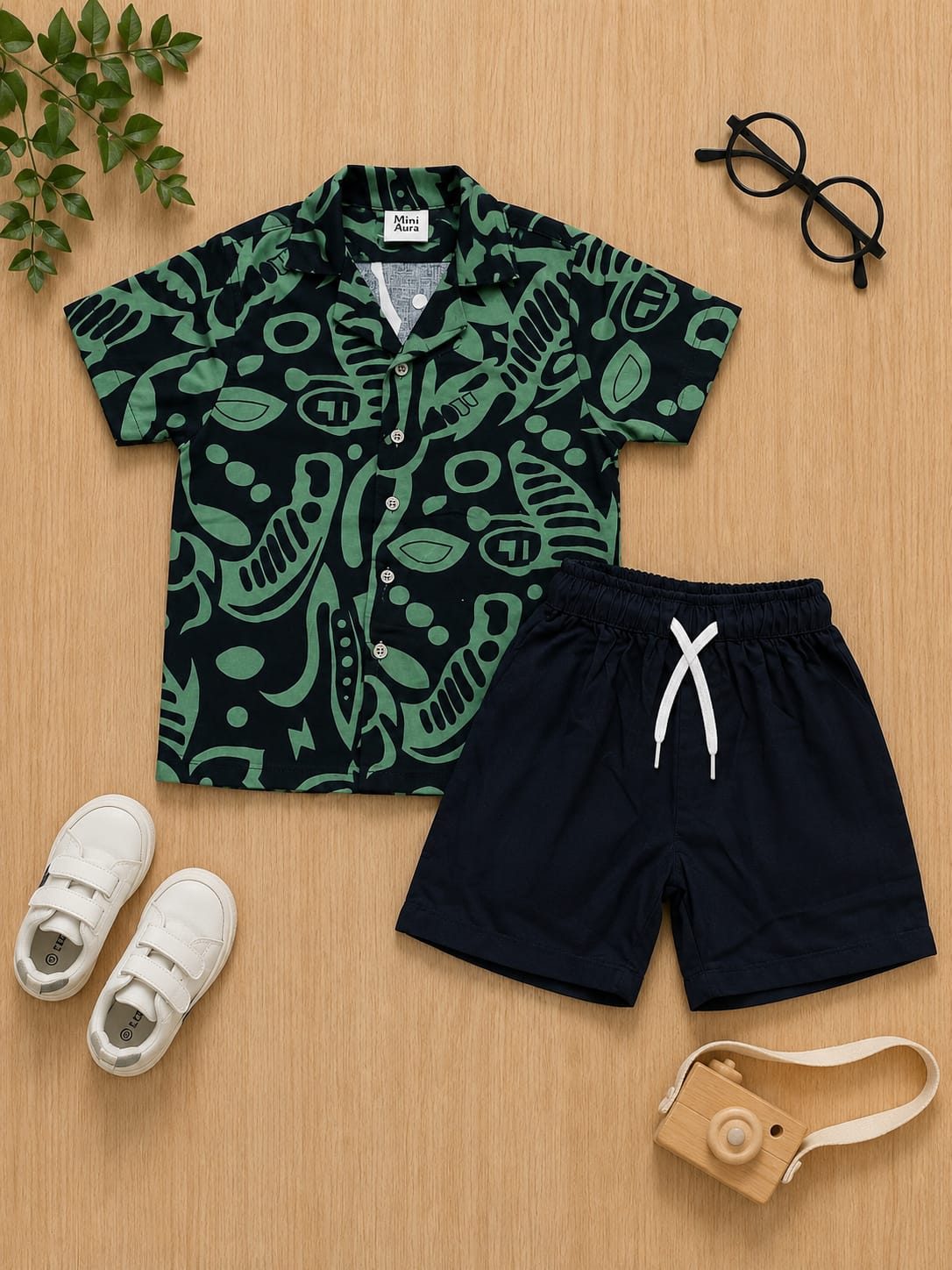Boys green and black abstract print short-sleeve button-down shirt with matching black shorts set.
