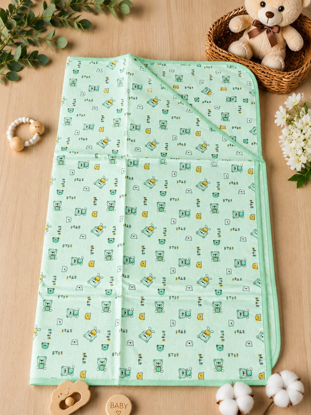 Mint green hooded baby blanket with cute teddy bear print.