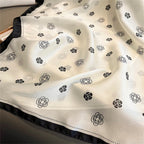 Ivory silk-satin scarf with black camellia flower line-art print and black bordered edge