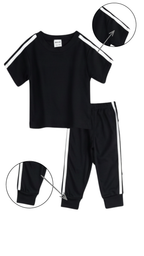 Girl wearing black t-shirt and jogger set with white side stripes