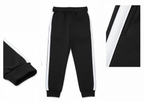 Girl wearing black t-shirt and jogger set with white side stripes